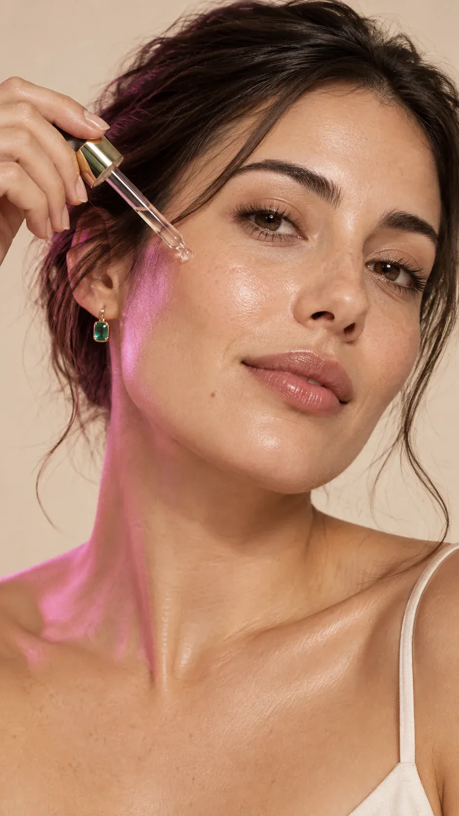 A woman applies serum in a natural skincare campaign portrait.